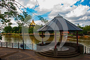 Pavilion near the water with views of the Dewan Undangan Negeri Sarawak. Kuching, Sarawak, Malaysia.