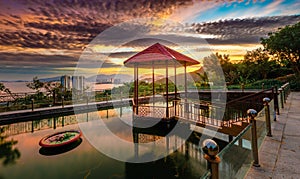 Pavilion on the pond at sunset. Panorama