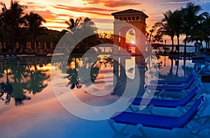 Pavilion on a sunset and the pool with reflection.