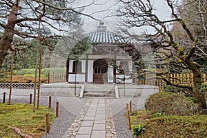 Pavilion surrounded by trees in Ryoanji Temple garden complex in February in Kyoto, Japan