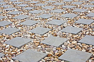 Paving, square pavers with round small stone in the middle