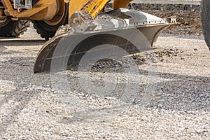 Paving the ground at road construction works with a bulldozer