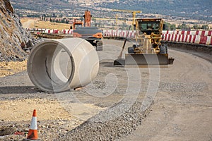 Paving the ground at road construction works with a bulldozer