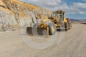 Paving the ground at road construction works with a bulldozer