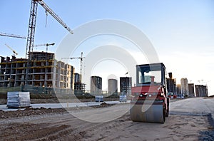 Paving roller machine during road work at construction site for paving works. Asphalt paver Road roller for Screeding the sand and