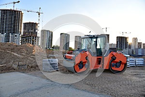 Paving roller machine during road work at construction site for paving works. Asphalt paver Road roller for Screeding the sand and