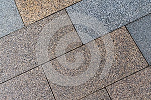 Paving slabs brown and gray stone background closeup urban pattern