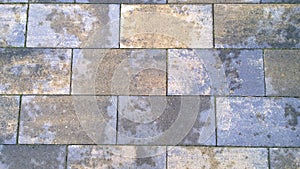 Paving slabs. Wet dirty surface after rain. Background of geometric shape. Gray, brown rectangles. Gradient effect. Grunge texture