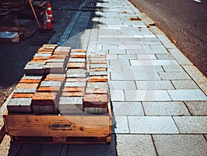 Paving stone installation with bricks and sidewalk construction materials