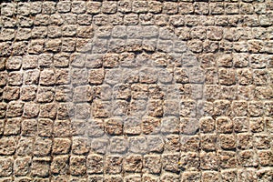 Paving stones lined with gray stones of a square shape.