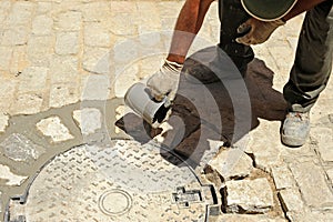 Paving a street in the traditional way with cobblestones in Seville, Spain