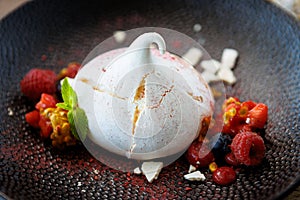 Pavlova berry cake with passion cream, strawberry, meringue. Delicious sweet dessert food closeup served for lunch in