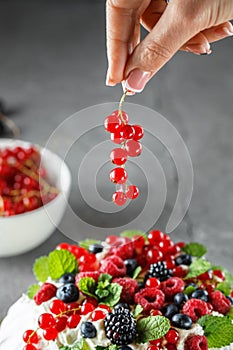 Pavlova cake with cream and fresh summer berries. Close up of Pavlova dessert with forest fruit and mint. Food photography. The