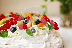 Pavlova cake with cream and fresh summer berries. Close up of Pavlova dessert with forest fruit and mint