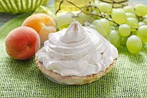 Pavlova cake with grapes and peaches