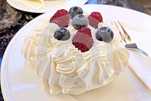 Pavlova, meringue dessert, topped with raspberries and blackberries