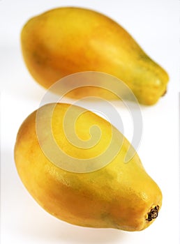 PAW PAW OR PAPAYA FRUIT carica papaya AGAINST WHITE BACKGROUND