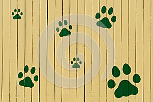 Paw prints on yellow fence
