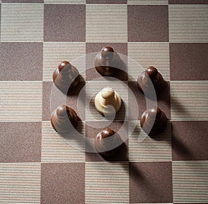 Pawn on chess board surrounded by adversary concept of adversity ,discimination ,equality photo