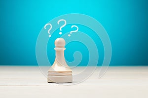 Pawn chess piece with question marks. Uncertainty, problem, confusion or decision in business concept