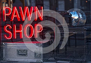 Pawn shop window with neon sign.