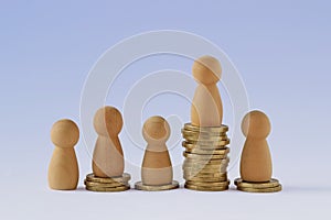 Pawns on stacks of coins - Concept of economic inequality