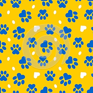 Paws of a cat, dog, puppy. Seamless cute pattern of animal footprints for textile. Blue and yellow colors.