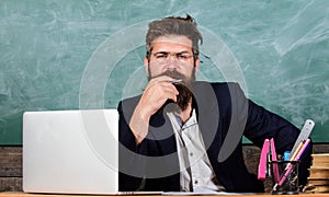 Pay attention to details. Teacher concentrated bearded mature schoolmaster listening with attention. Teacher listening