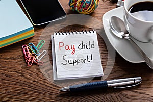 Pay Child Support Concept Written On Notepad