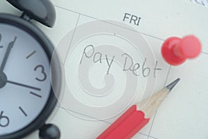 Pay debt word on calendar date, close up
