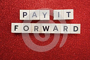 Pay It Forward alphabet letter on red glitter background