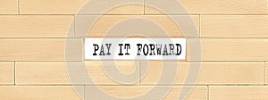 Pay It Forward alphabet letter on the wooden background