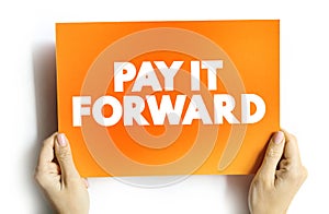 PAY IT FORWARD text quote on card, concept background