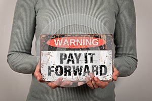 Pay It Forward. Warning sign with text woman in hand