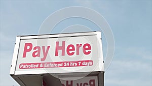 pay here patrolled and enforced 24 hours 7 days rectangle sign above pay meter..