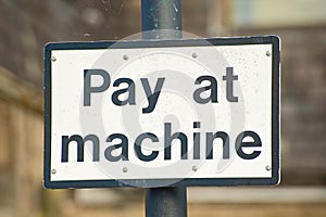 Pay at machine sign.