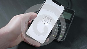 Pay by phone on the POS contactless payment terminal. A user makes a purchase using a smartphone in a store or