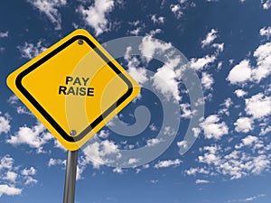 Pay raise traffic sign on blue sky