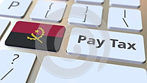 PAY TAX text and flag of Angola on the buttons on the computer keyboard. Taxation related conceptual 3D animation