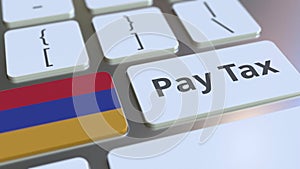 PAY TAX text and flag of Armenia on the buttons on the computer keyboard. Taxation related conceptual 3D rendering