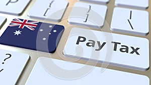 PAY TAX text and flag of Australia on the buttons on the computer keyboard. Taxation related conceptual 3D rendering