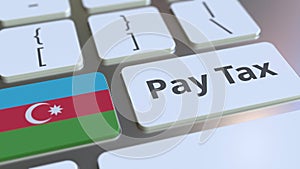 PAY TAX text and flag of Azerbaijan on the buttons on the computer keyboard. Taxation related conceptual 3D animation
