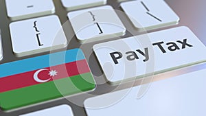 PAY TAX text and flag of Azerbaijan on the buttons on the computer keyboard. Taxation related conceptual 3D rendering