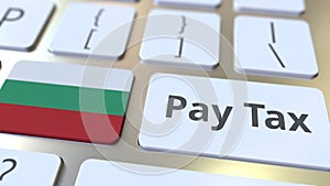 PAY TAX text and flag of Bulgaria on the buttons on the computer keyboard. Taxation related conceptual 3D rendering