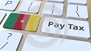 PAY TAX text and flag of Cameroon on the buttons on the computer keyboard. Taxation related conceptual 3D animation