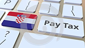 PAY TAX text and flag of Croatia on the buttons on the computer keyboard. Taxation related conceptual 3D rendering