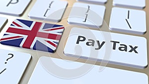 PAY TAX text and flag of Great Britain on the buttons on the computer keyboard. Taxation related conceptual 3D rendering