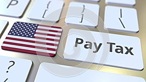 Pay tax text and flag of the United States on the buttons on the computer keyboard. Taxation related conceptual 3D