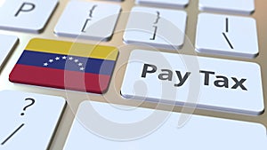 Pay tax text and flag of Venezuela on the buttons on the computer keyboard. Taxation related conceptual 3D animation