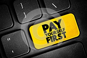 Pay Yourself First text button on keyboard, concept background